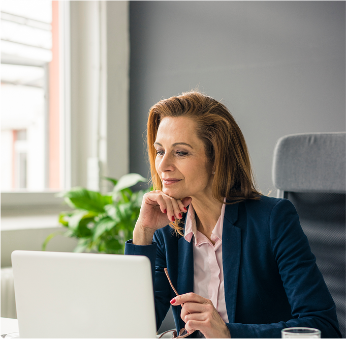 businesswoman-sitting-in-office-working-on-laptop-2022-12-16-21-59-36-utc 1